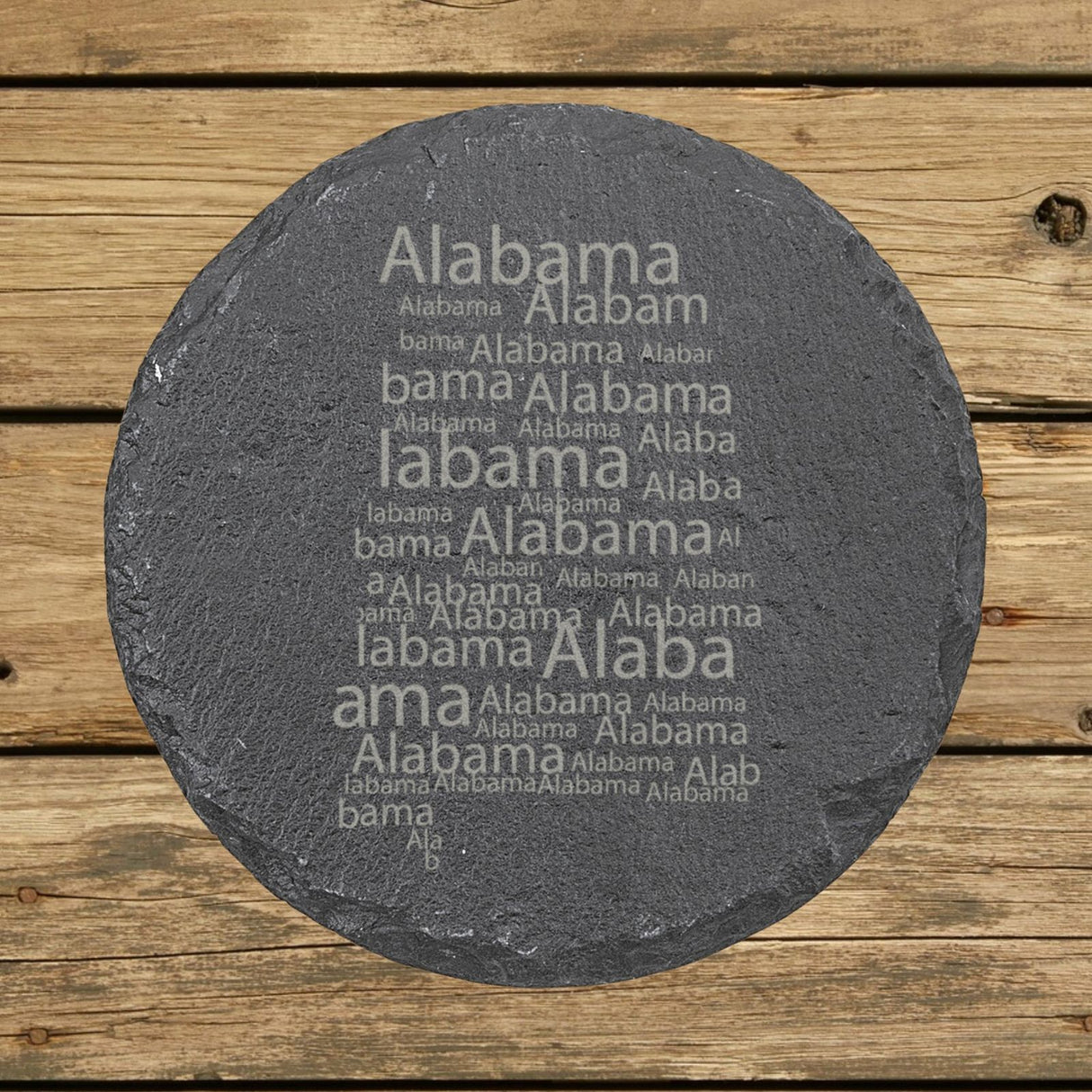 Alabama round slate coaster engraved with a word cloud of repeating Alabama text