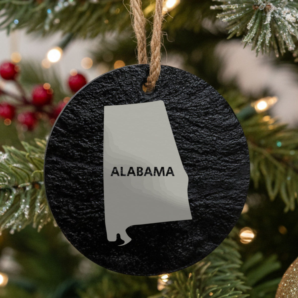 Alabama round slate Christmas ornament engraved with the state shape and ALABAMA in bold lettering