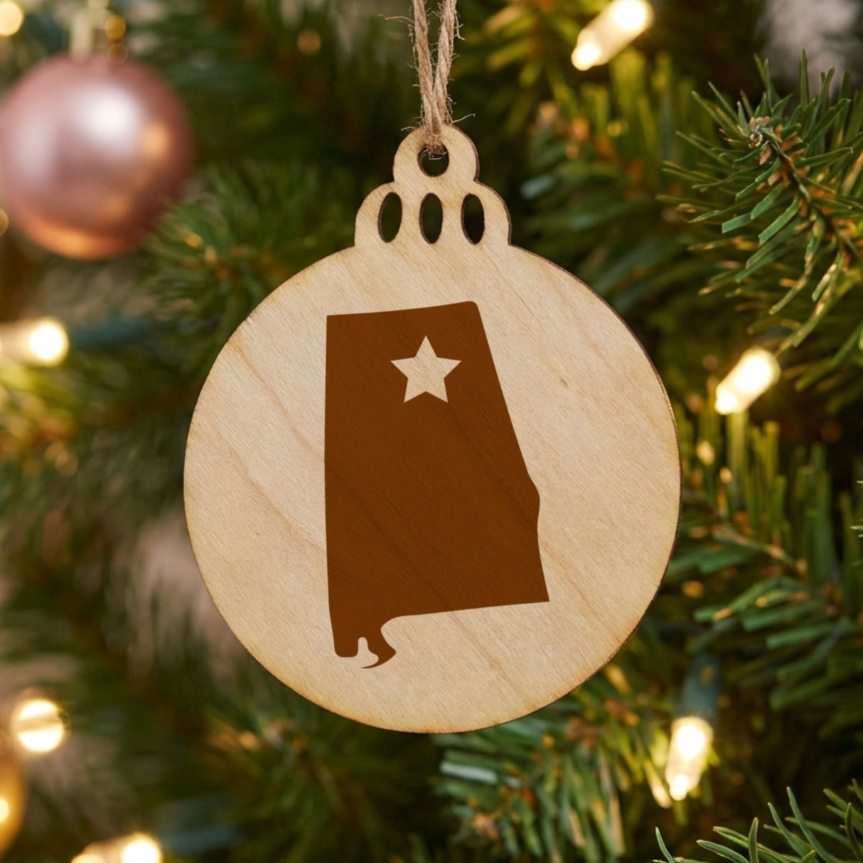 Alabama round wood Christmas ornament engraved with the state shape and a star