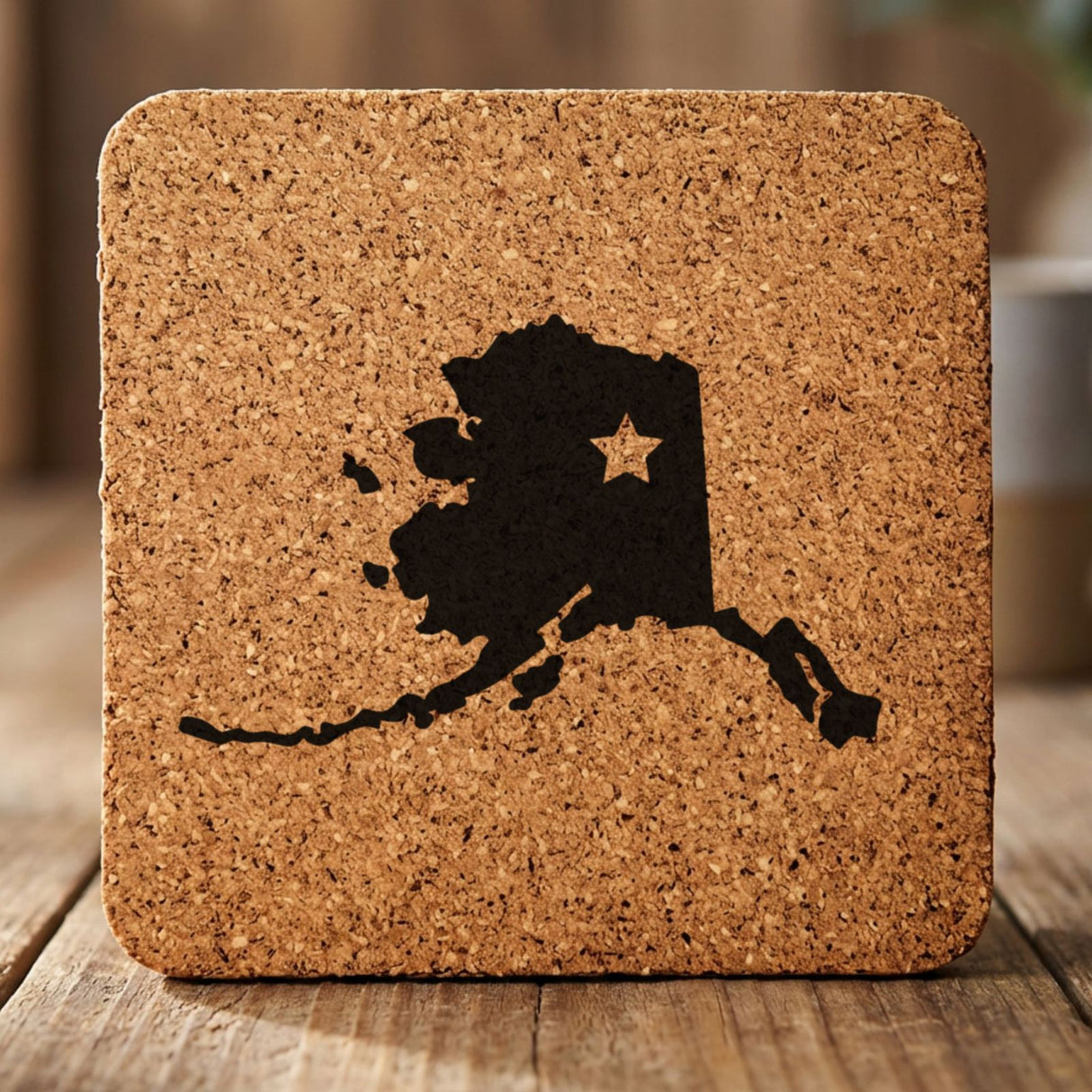 Alaska square cork coaster engraved with the state shape and a star
