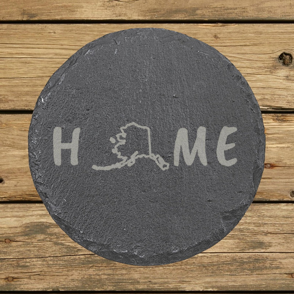 Alaska round slate coaster engraved with HOME using the state outline as the letter O