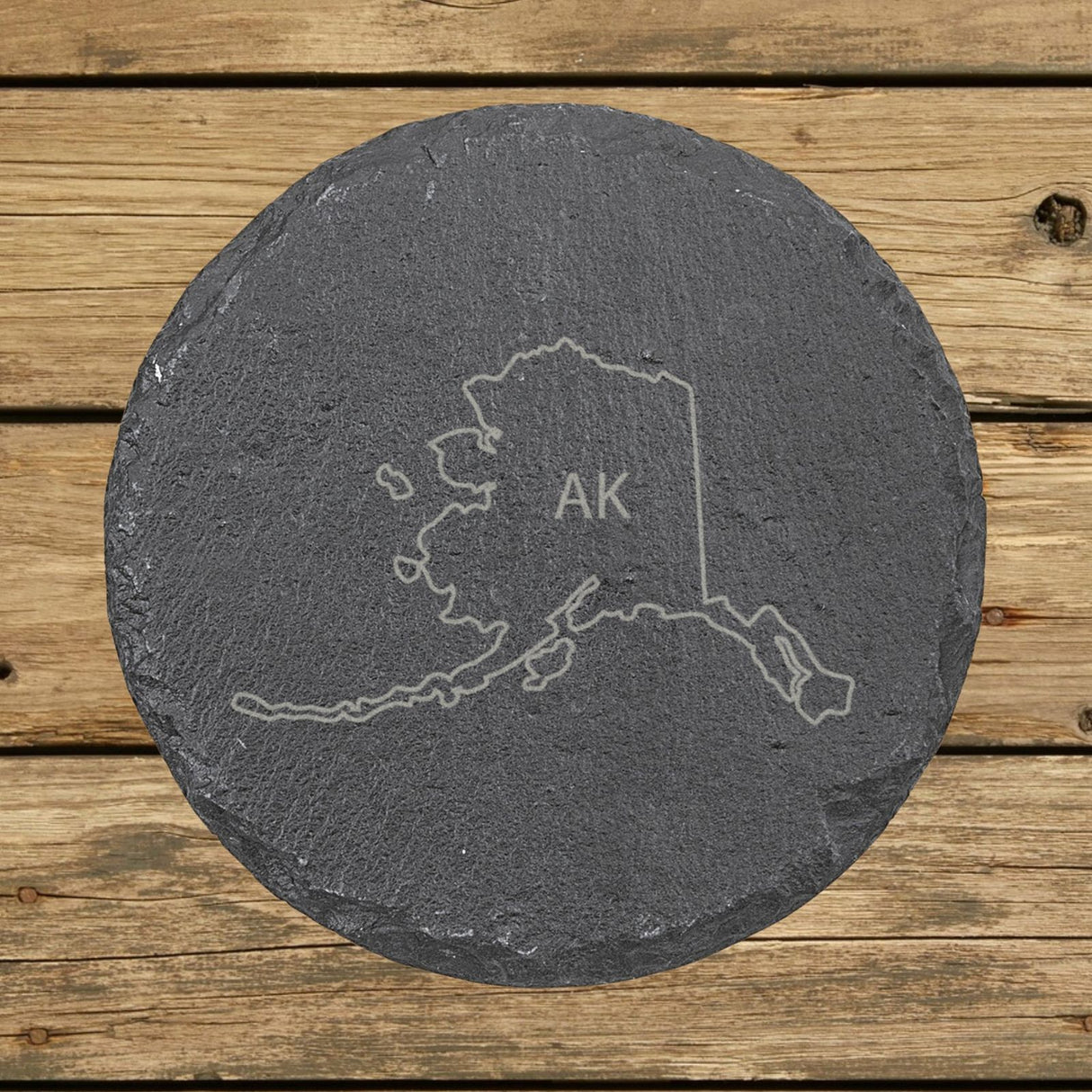 Alaska round slate coaster engraved with the state outline and AK initials