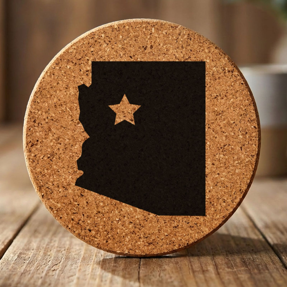 Arizona round cork coaster engraved with the state shape and a star