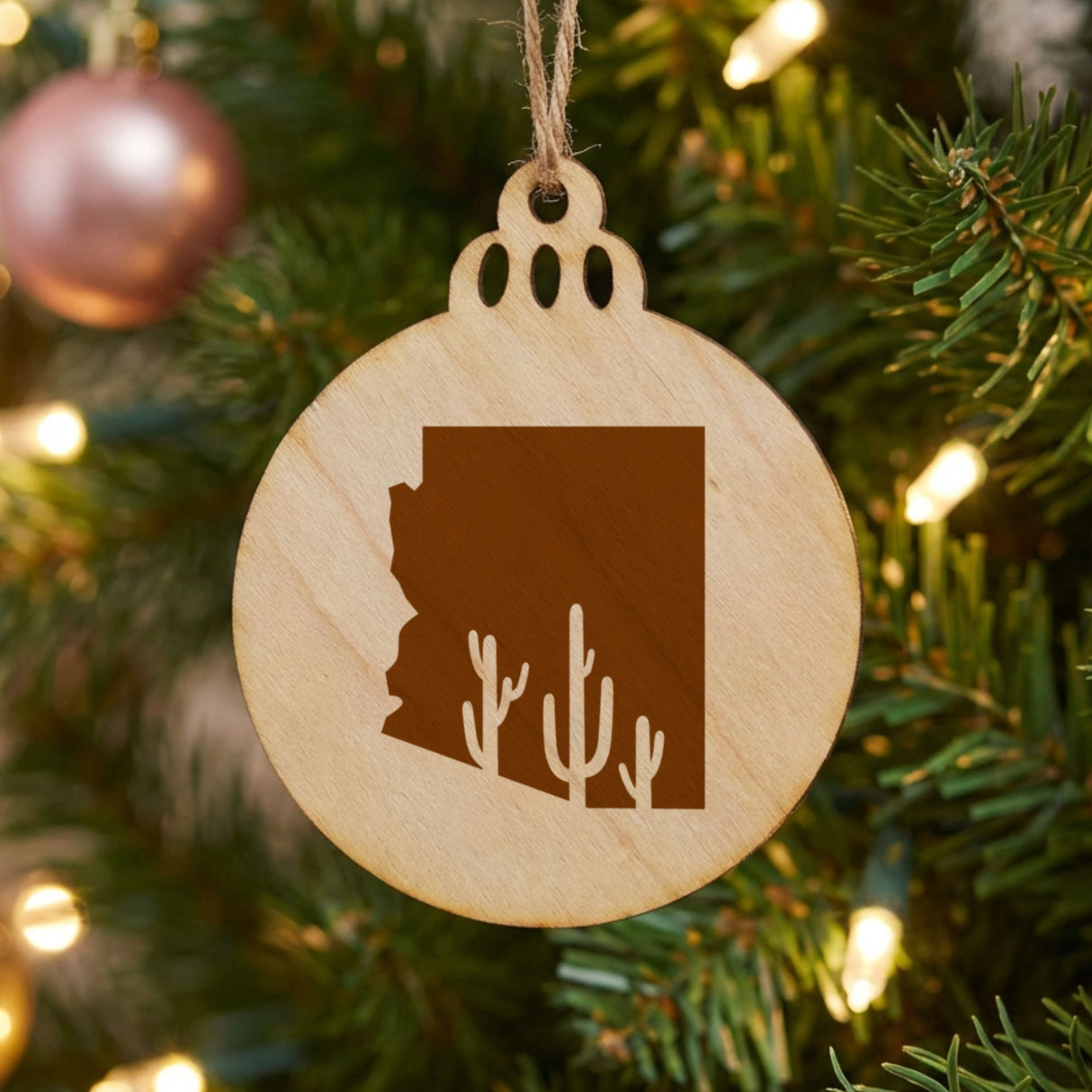Arizona round wood Christmas ornament engraved with the state outline and a saguaro cactus