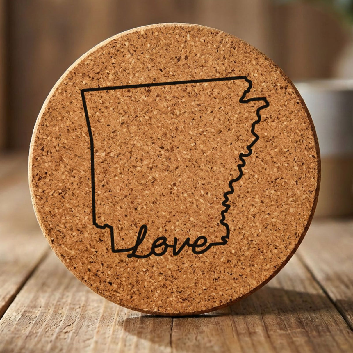Arkansas round cork coaster engraved with a hand-drawn state outline and love in cursive