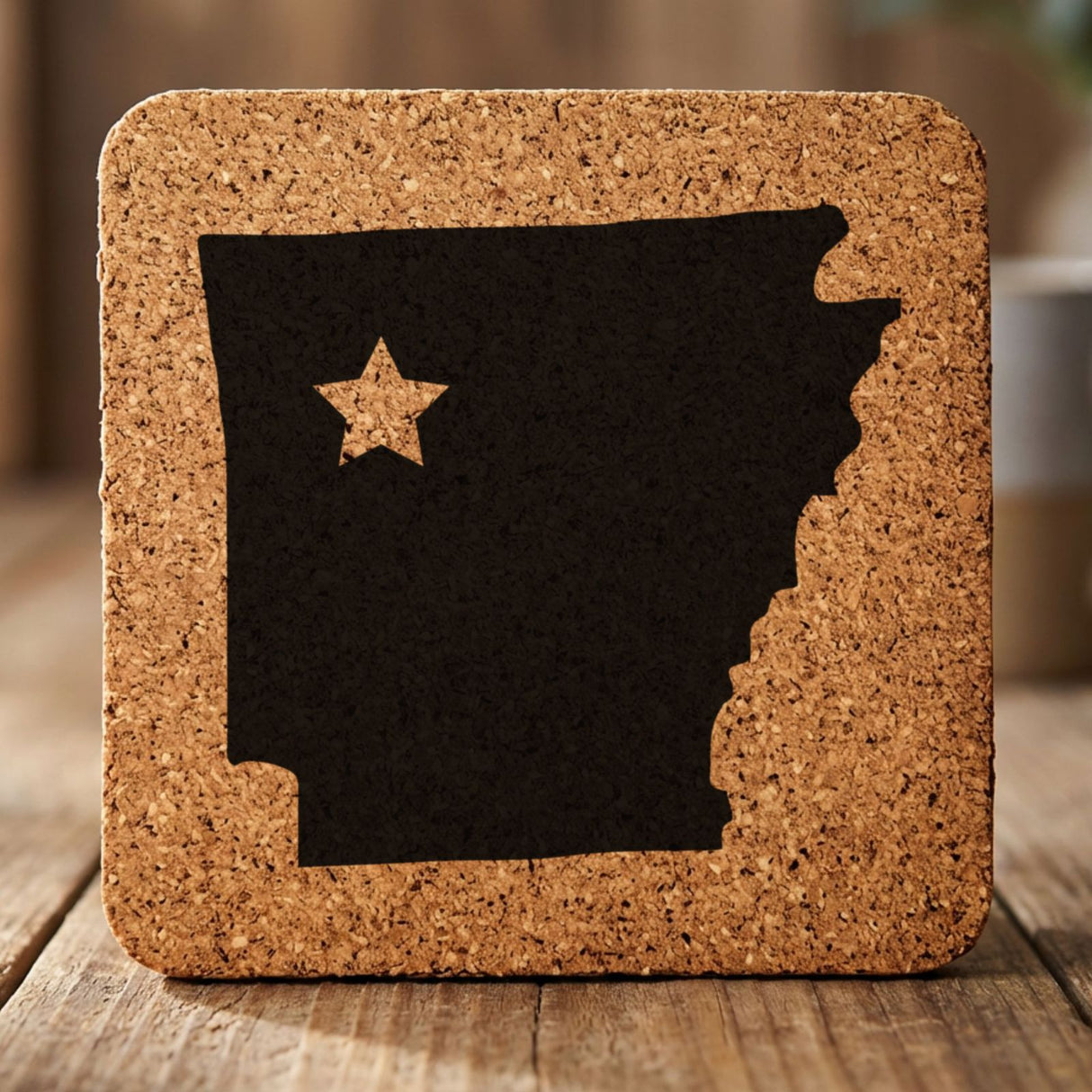 Arkansas square cork coaster engraved with the state shape and a star
