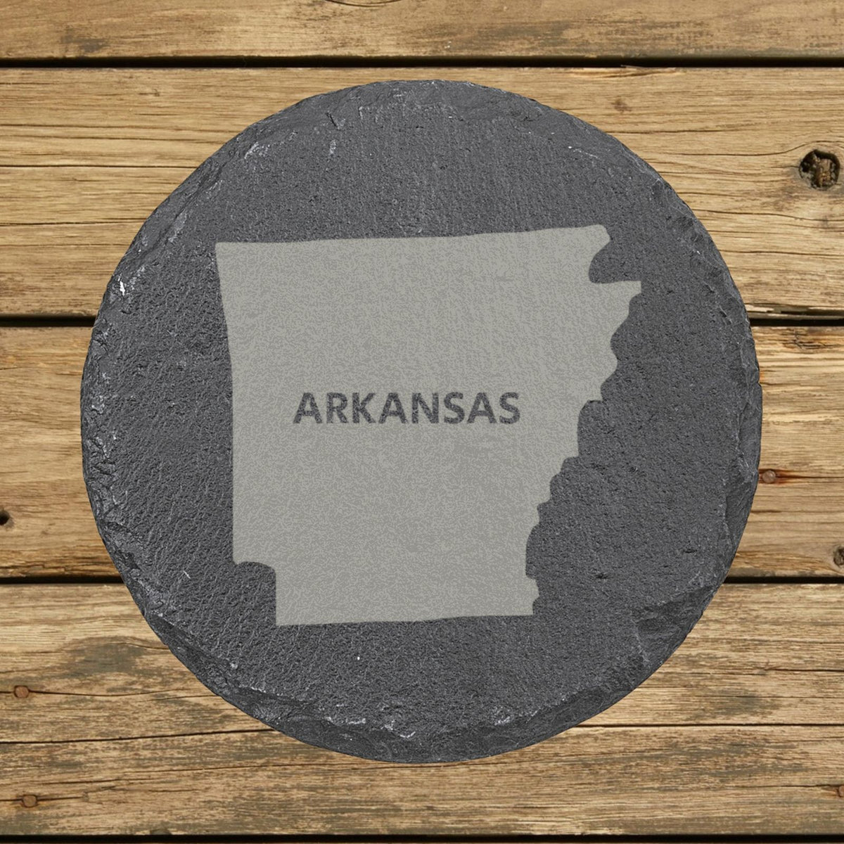 Arkansas round slate coaster engraved with the state shape and ARKANSAS in bold lettering