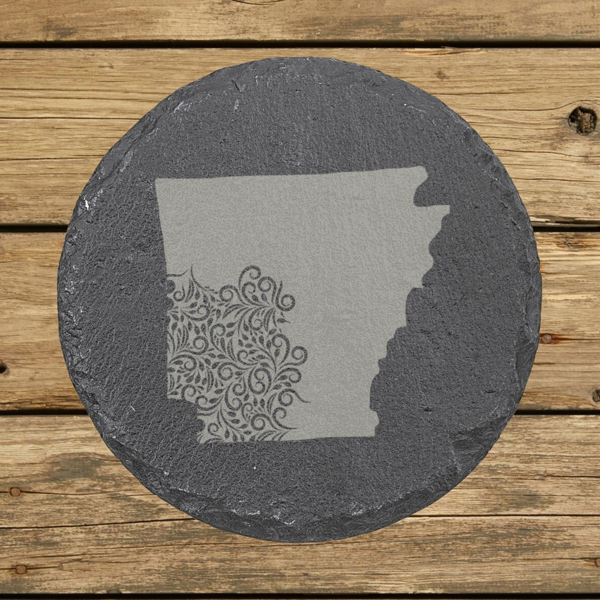 Arkansas round slate coaster engraved with the state shape in ornate floral scrollwork