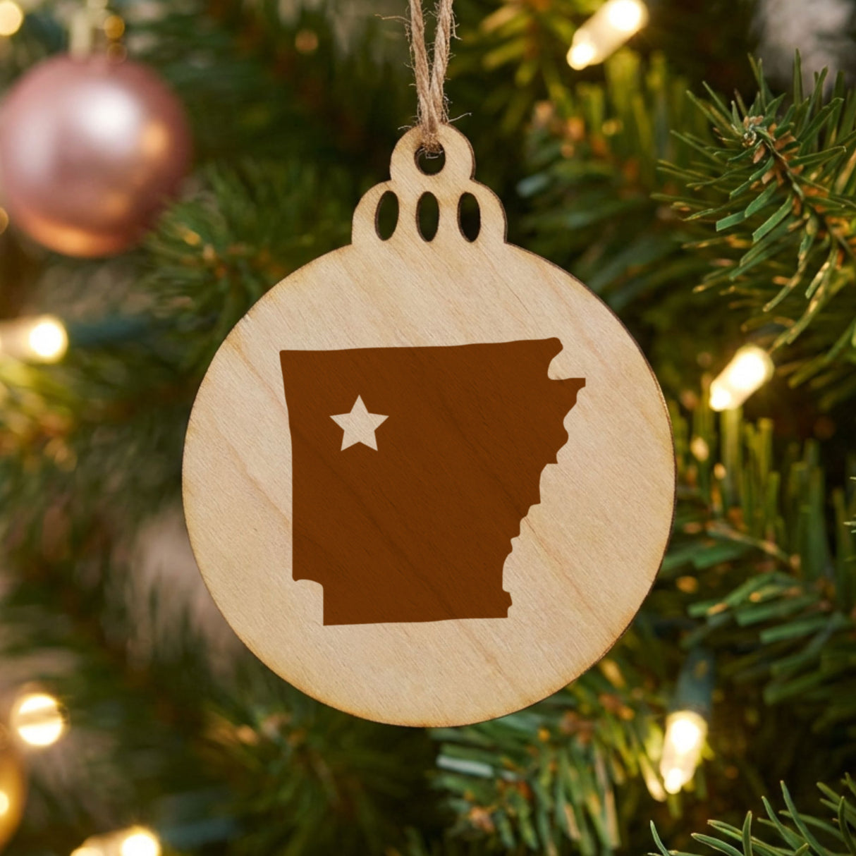 Arkansas round wood Christmas ornament engraved with the state shape and a star