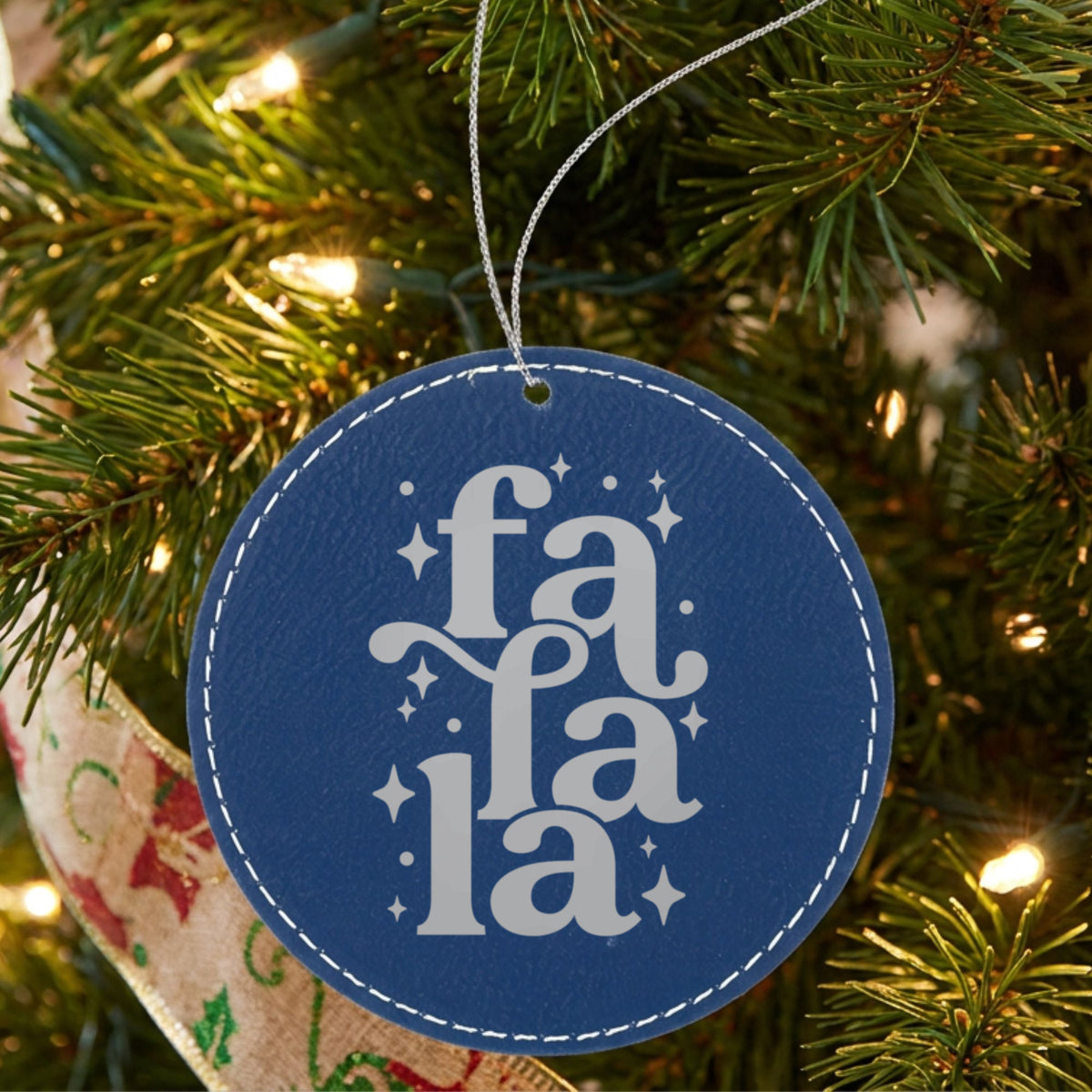 Blue leatherette Christmas ornament engraved with Fa La La