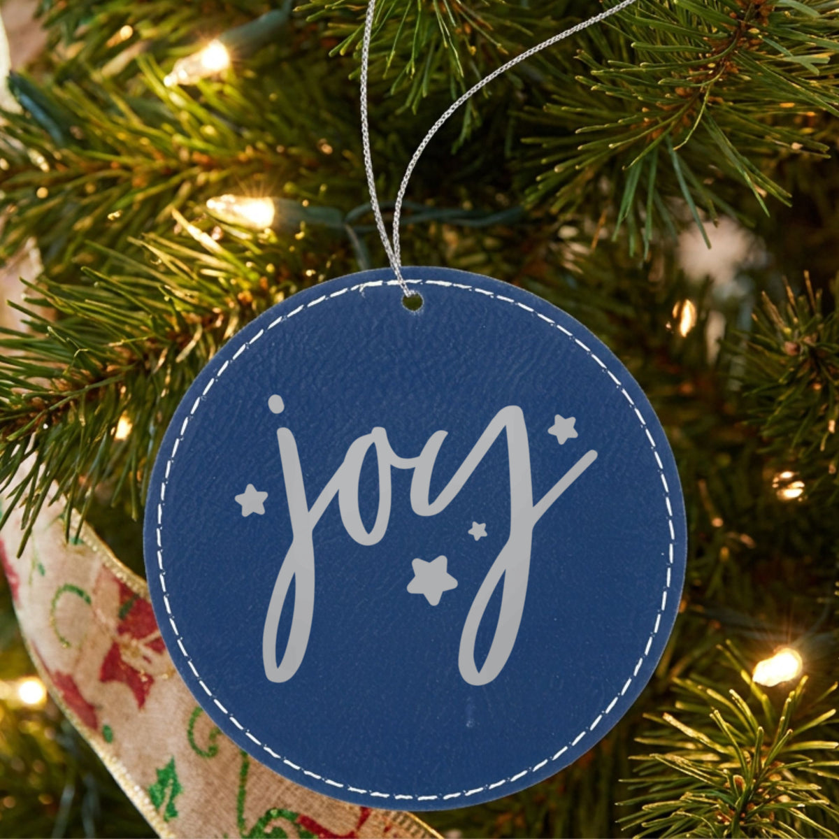 Blue leatherette Christmas ornament engraved with Joy