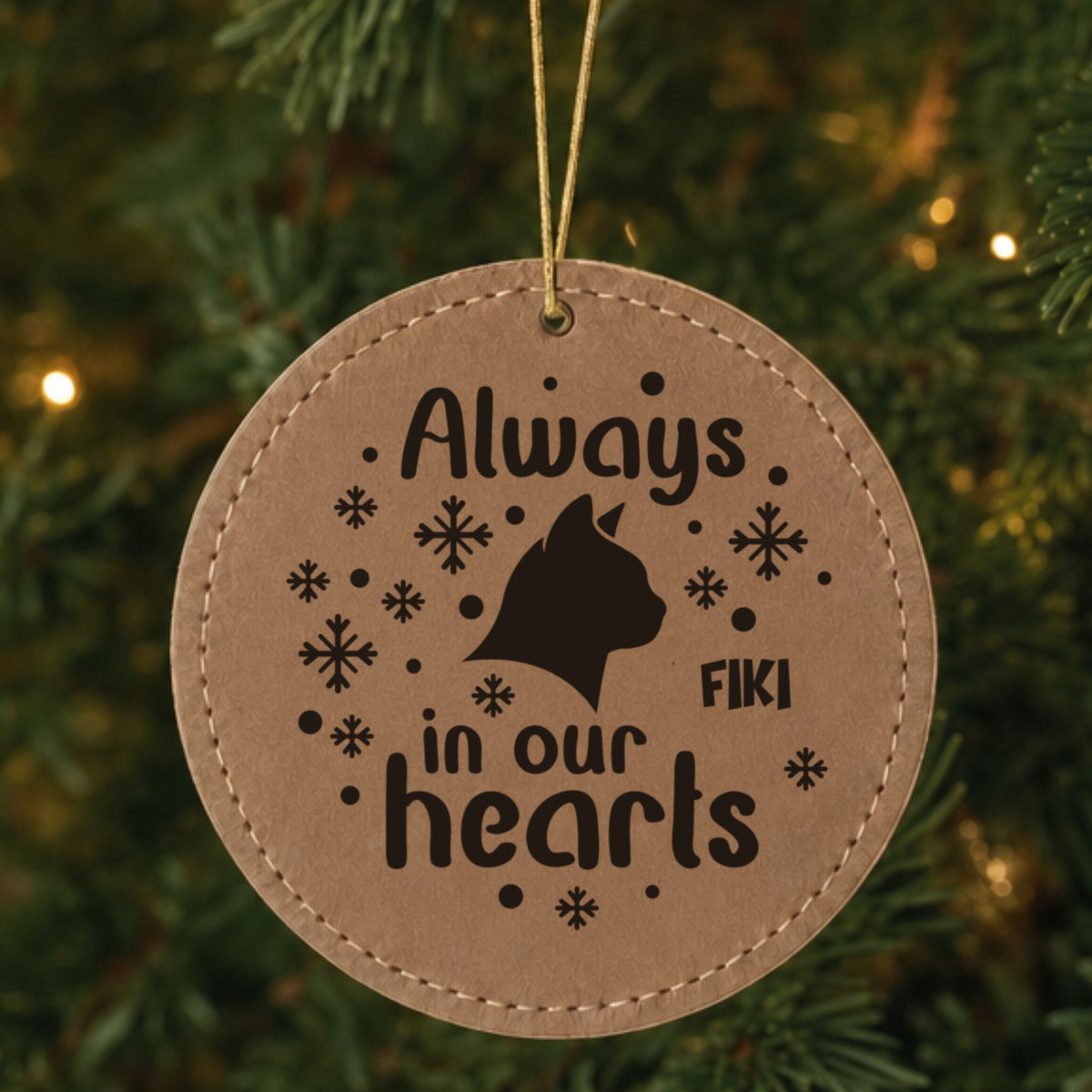 Brown leatherette Christmas ornament engraved with the Always in Our Hearts cat design and a sample pet name