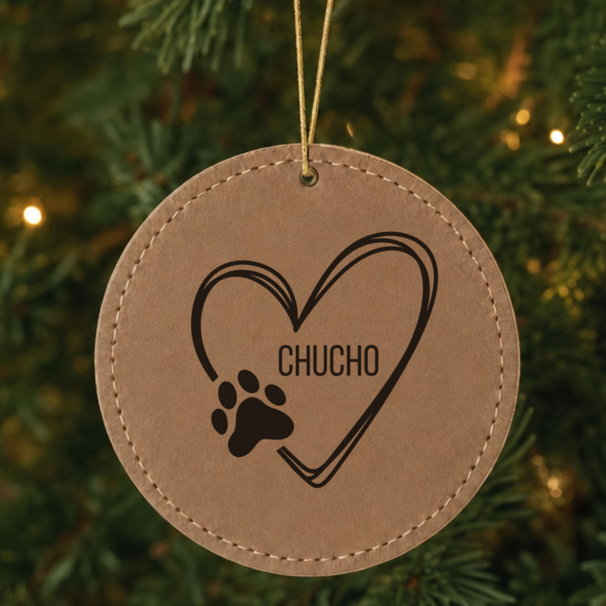 Brown leatherette Christmas ornament engraved with the heart and paw print design and a sample pet name