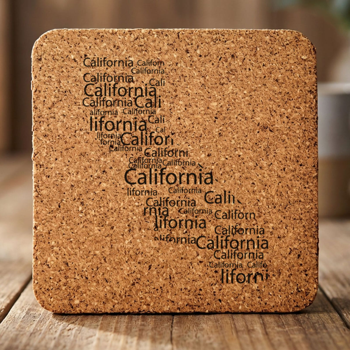 California square cork coaster engraved with a word cloud of repeating California text