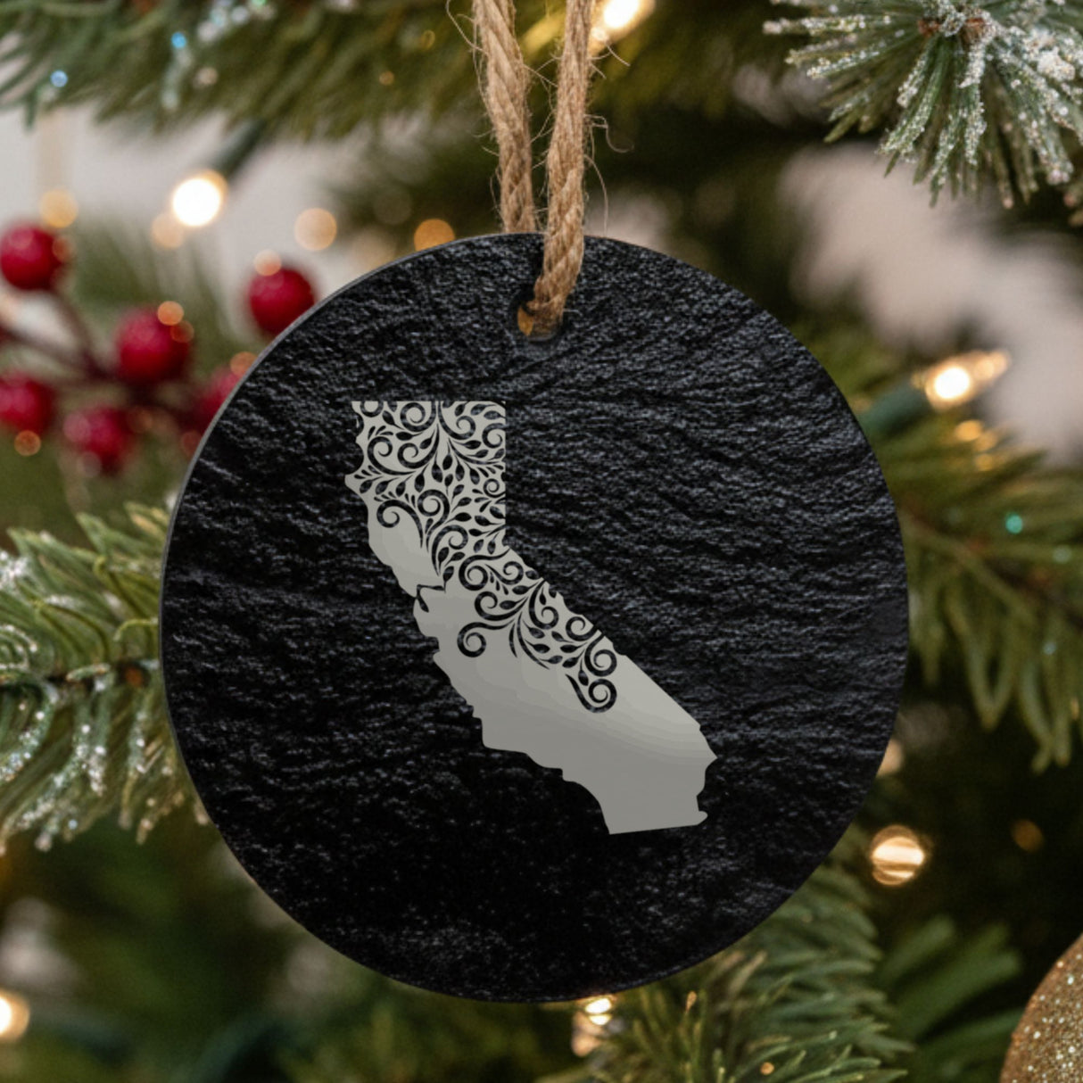 California round slate Christmas ornament engraved with the state shape in ornate floral scrollwork
