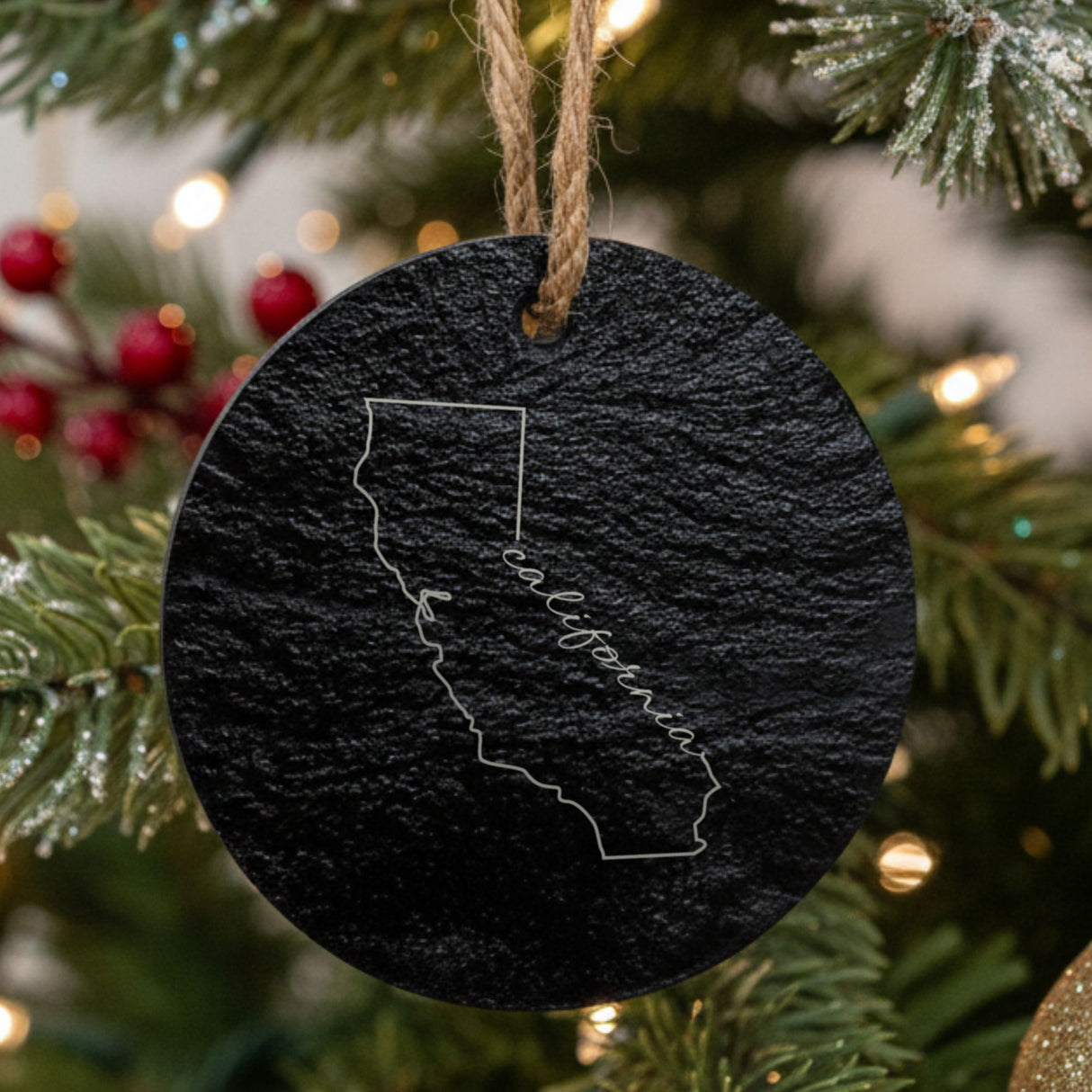 California round slate Christmas ornament engraved with the state outline and California in script lettering
