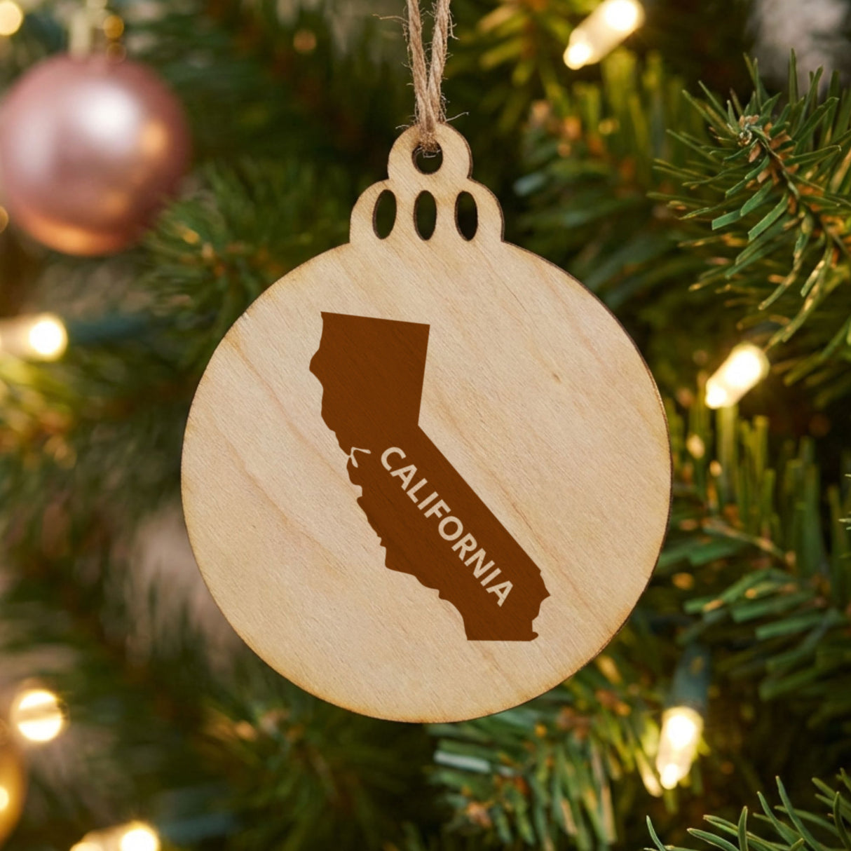California round wood Christmas ornament engraved with the state shape and CALIFORNIA in bold lettering