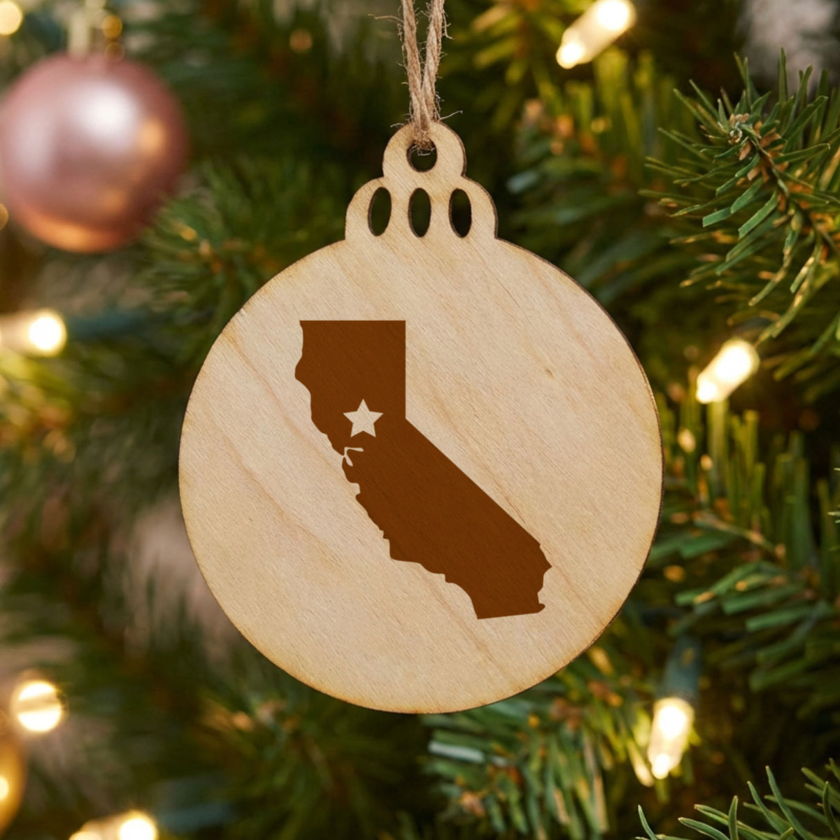 California round wood Christmas ornament engraved with the state shape and a star