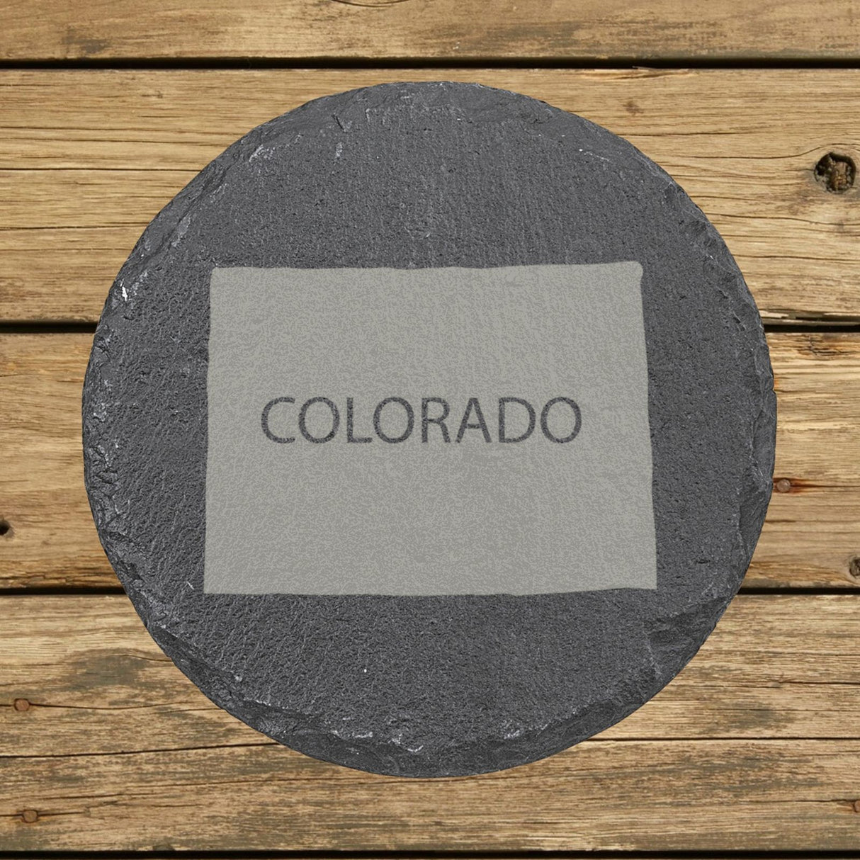 Colorado round slate coaster engraved with the state shape and COLORADO in bold lettering