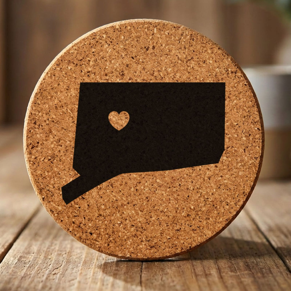Connecticut round cork coaster engraved with the state shape and a heart