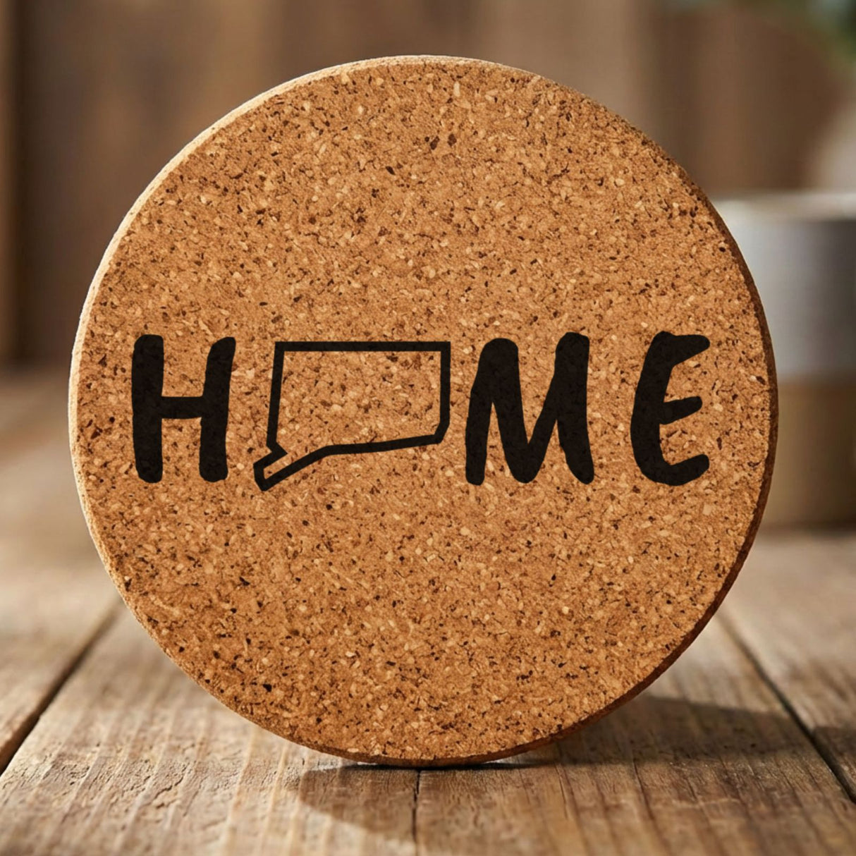 Connecticut round cork coaster engraved with HOME using the state outline as the letter O