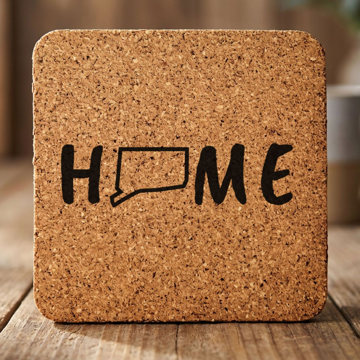 Connecticut square cork coaster engraved with HOME using the state outline as the letter O