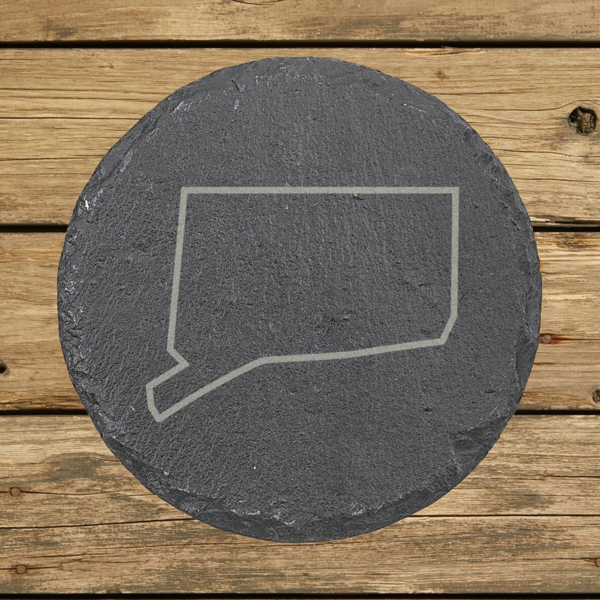 Connecticut round slate coaster engraved with a clean state outline