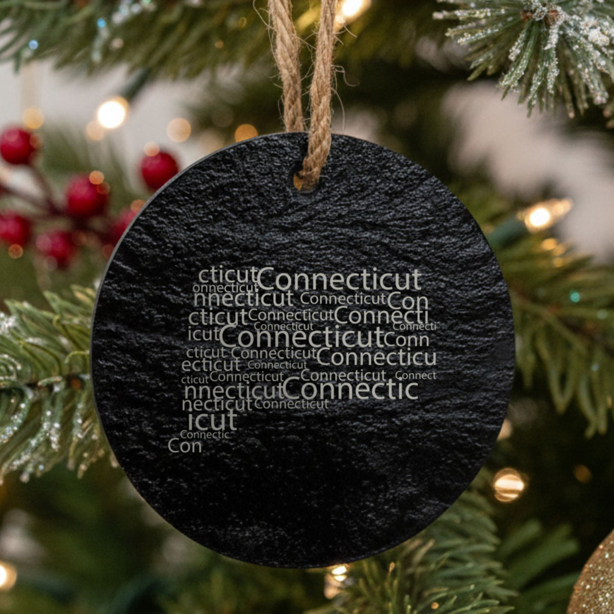 Connecticut round slate Christmas ornament engraved with a word cloud of repeating Connecticut text