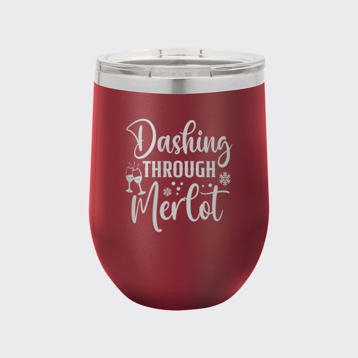Maroon 12 oz stemless wine tumbler laser engraved with "Dashing Through Merlot"
