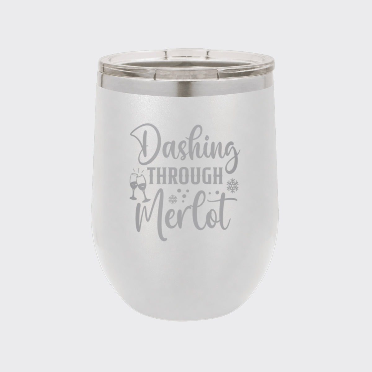 White 12 oz stemless wine tumbler laser engraved with "Dashing Through Merlot"