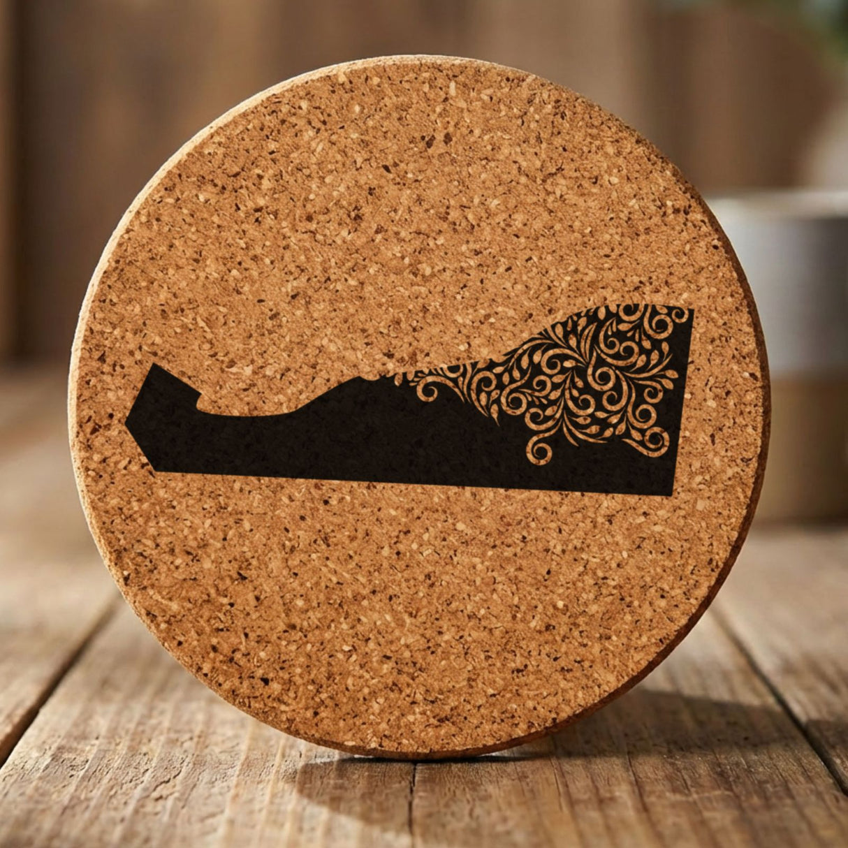 Delaware round cork coaster engraved with the state shape in ornate floral scrollwork