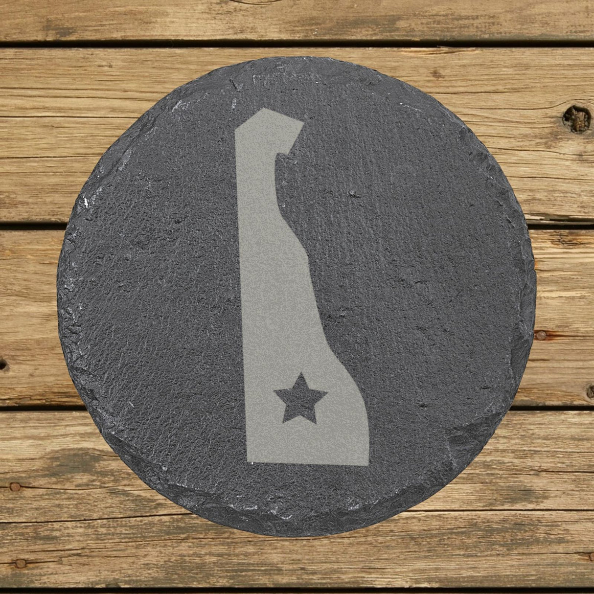 Delaware round slate coaster engraved with the state shape and a star