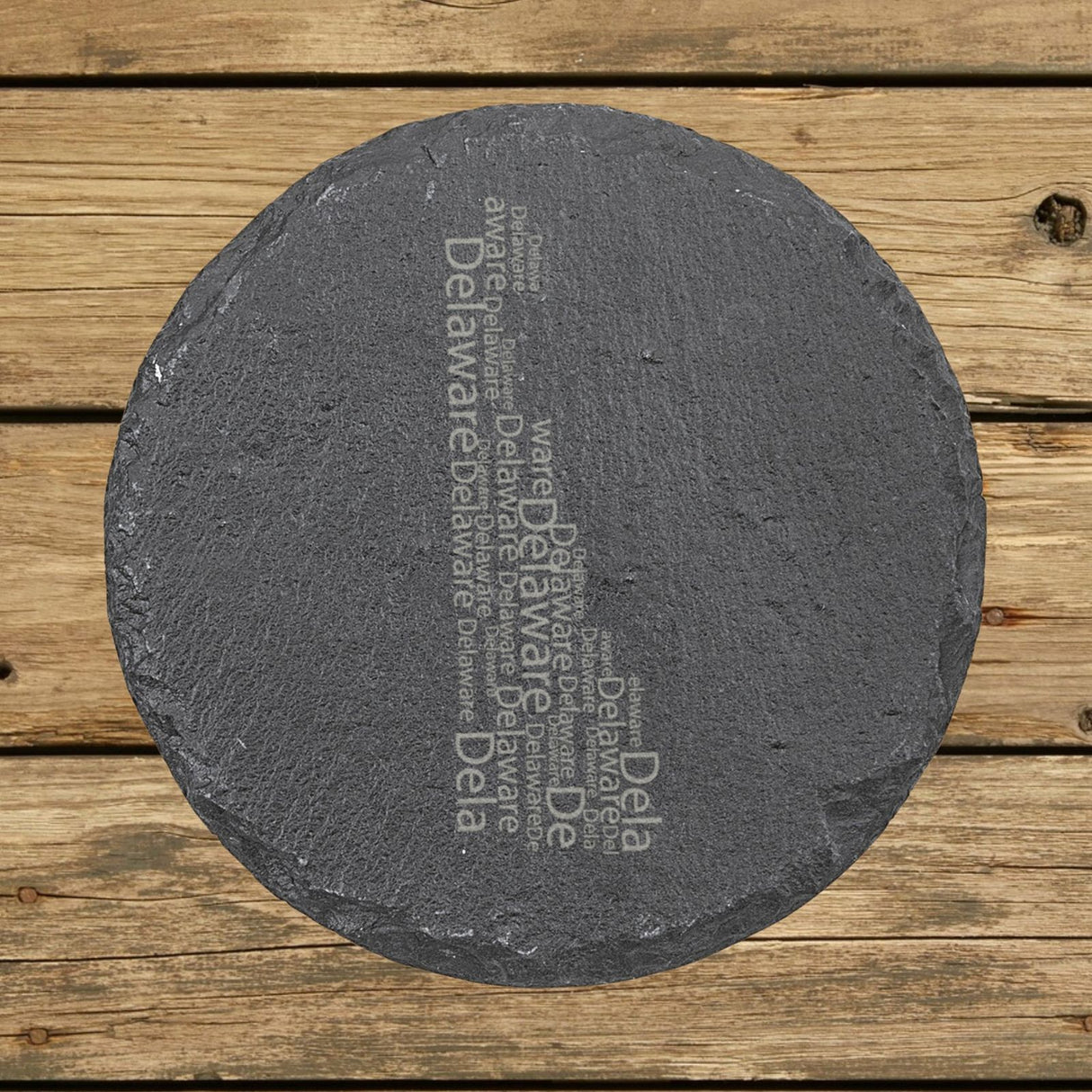 Delaware round slate coaster engraved with a word cloud of repeating Delaware text