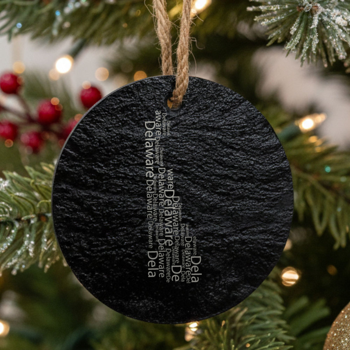 Delaware round slate Christmas ornament engraved with a word cloud of repeating Delaware text