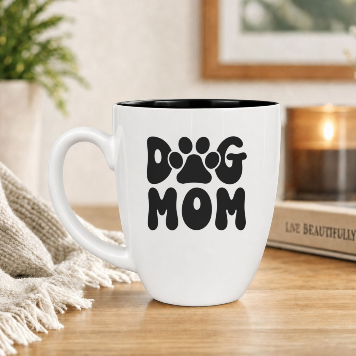 White 16 oz ceramic coffee mug printed with a retro bubble letter Dog Mom design with a paw print