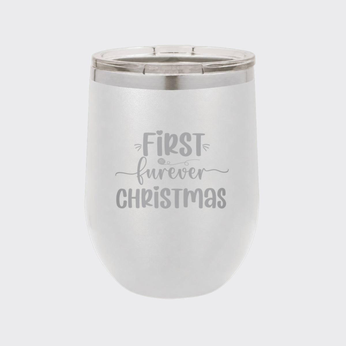 White 12 oz stemless wine tumbler laser engraved with "First Furever Christmas"