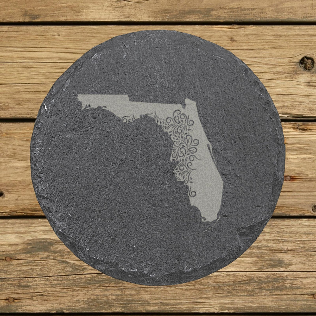 Florida round slate coaster engraved with the state shape in ornate floral scrollwork