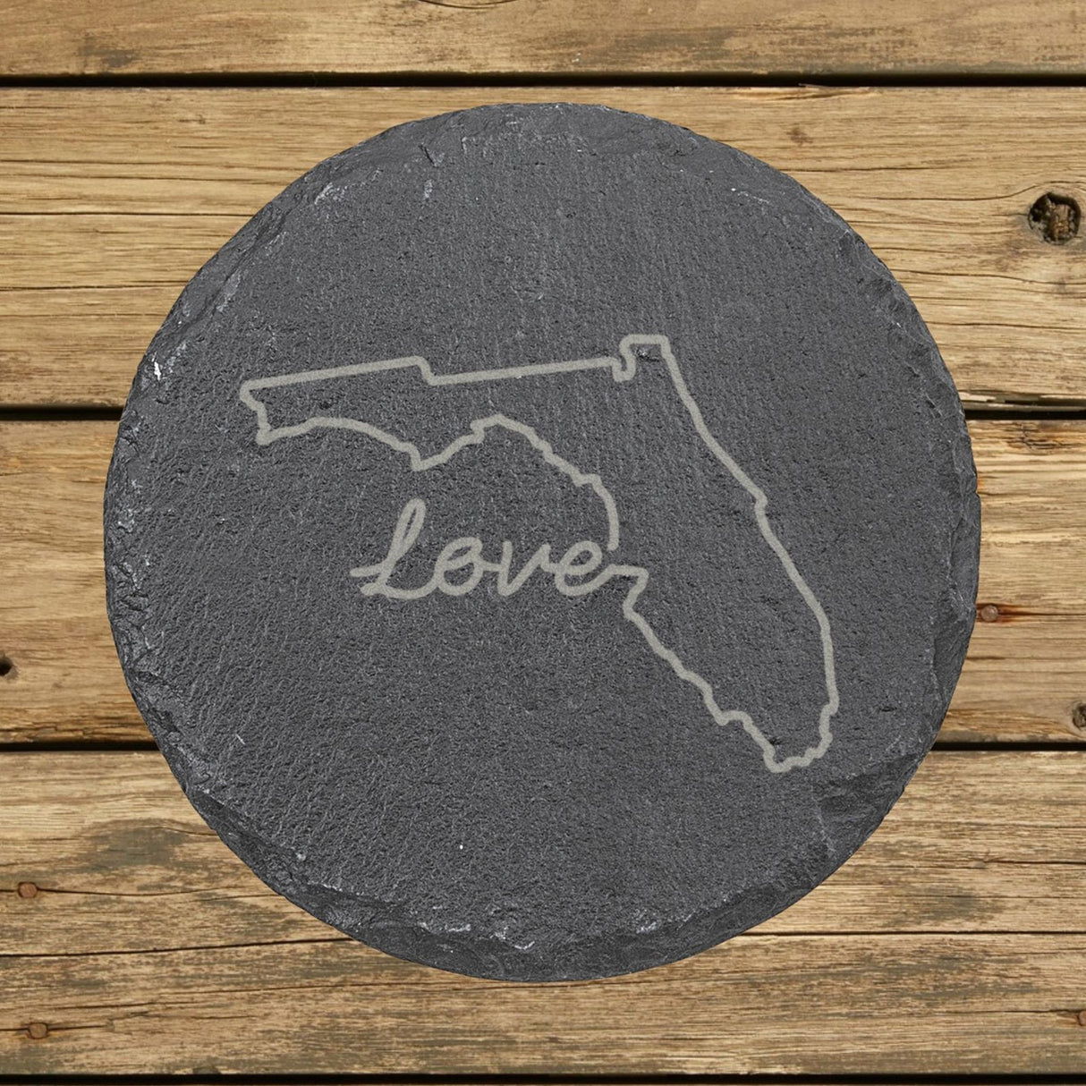 Florida round slate coaster engraved with a hand-drawn state outline and love in cursive