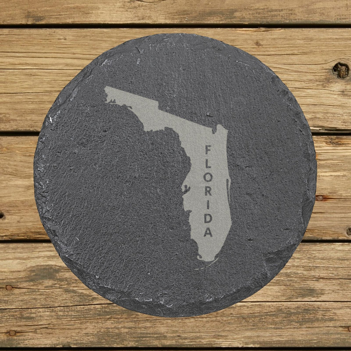 Florida round slate coaster with the engraved state shape and FLORIDA running vertically