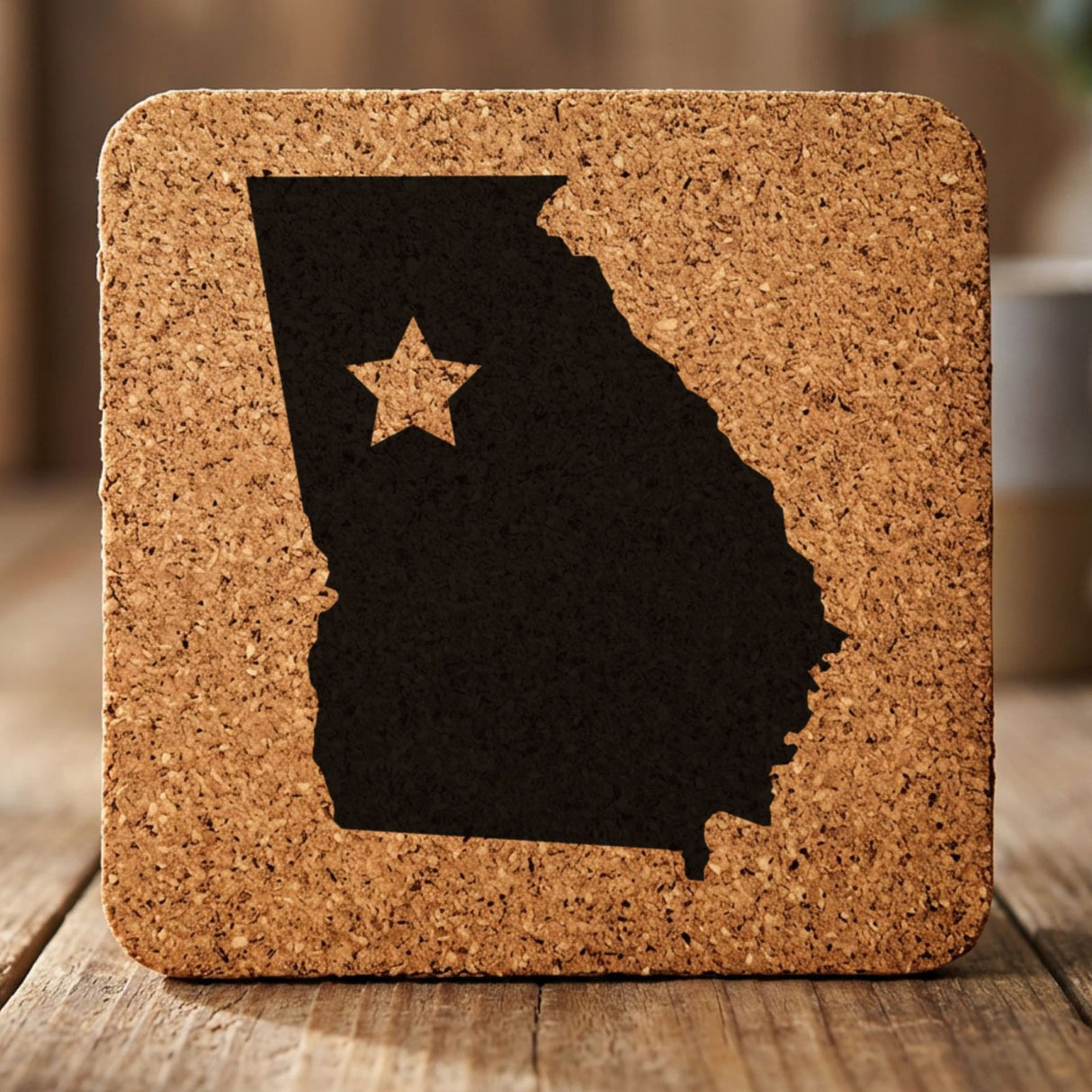 Georgia square cork coaster engraved with the state shape and a star