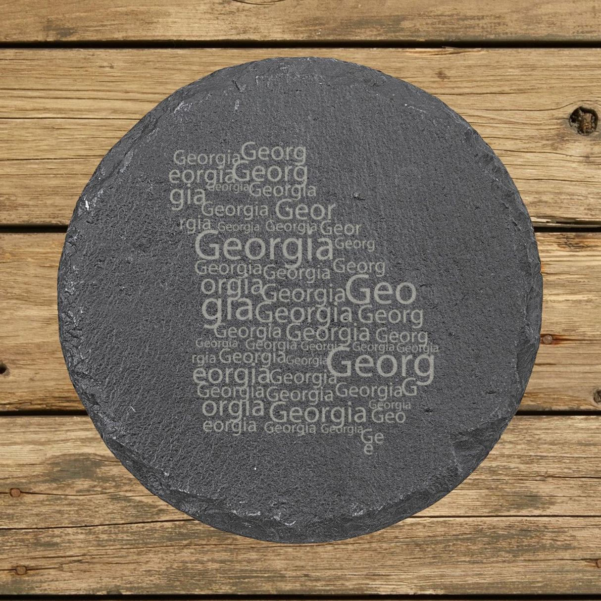 Georgia round slate coaster engraved with a word cloud of repeating Georgia text
