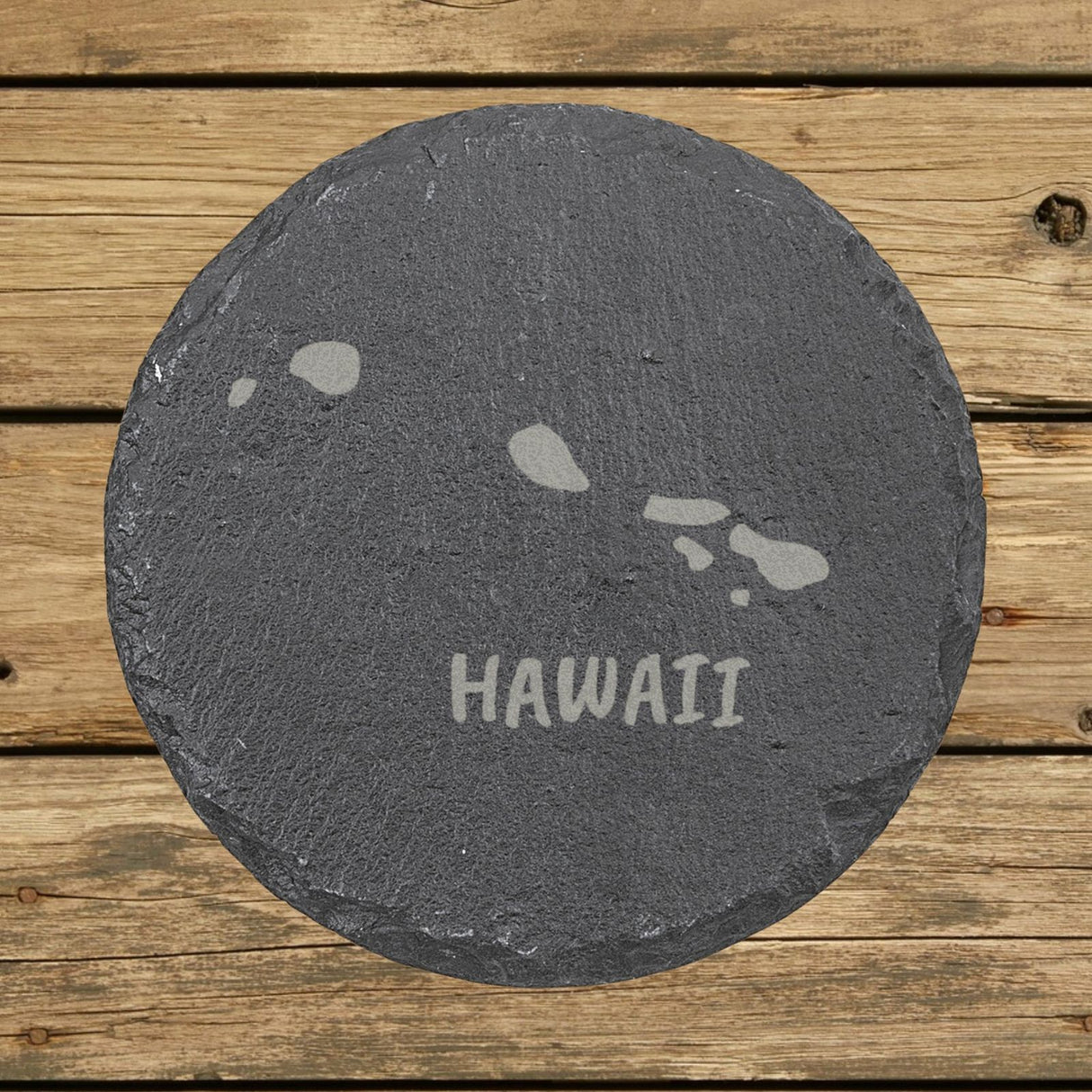 Hawaii round slate coaster engraved with the state outline and HAWAII in hand-drawn brush lettering