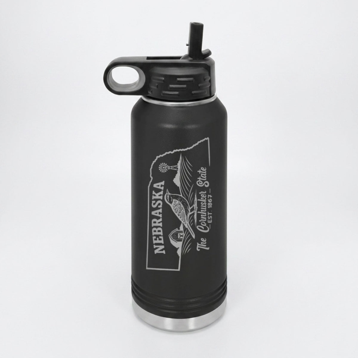 Black 32 oz insulated water bottle laser engraved with a Nebraska design of a western meadowlark, a barn and a windmill