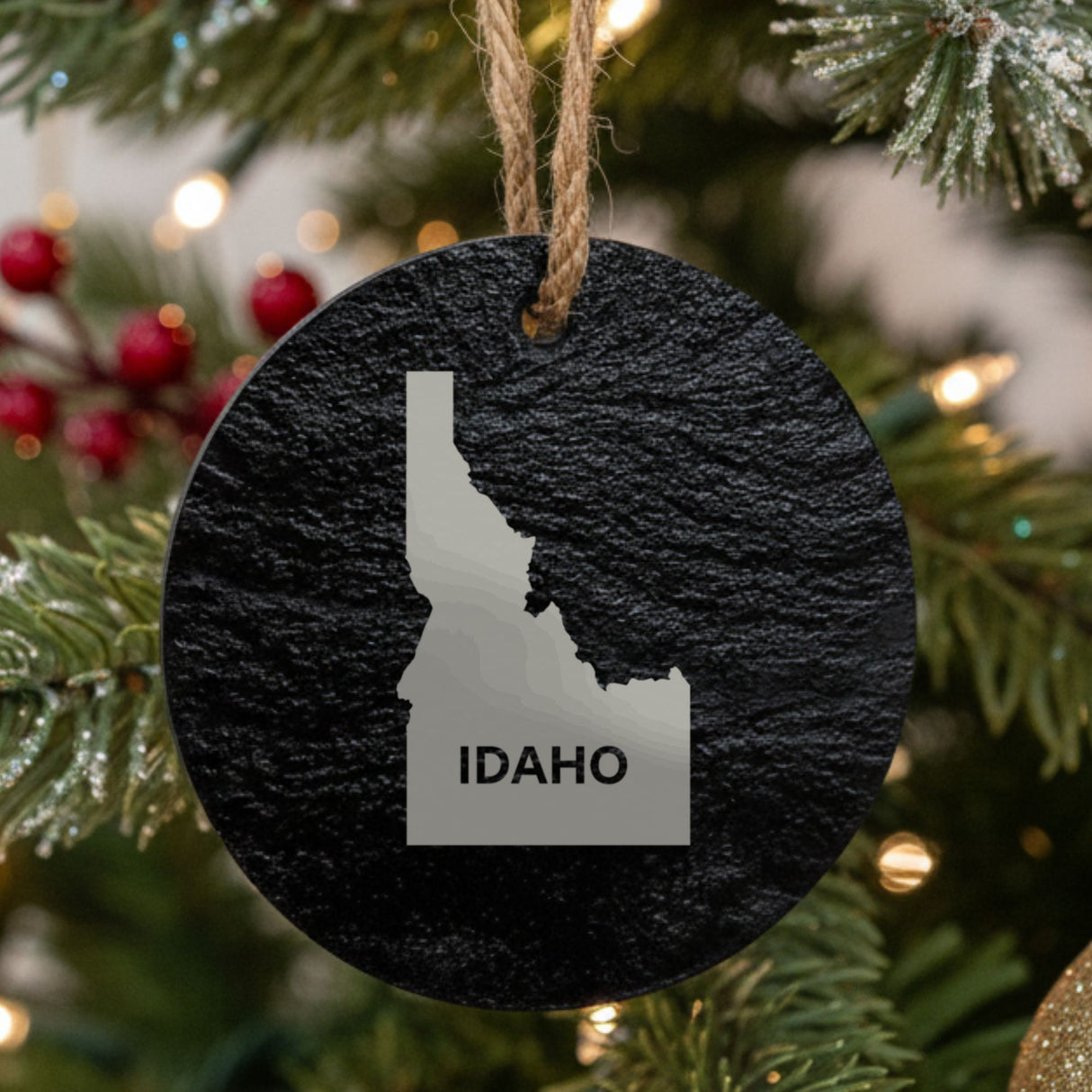 Idaho round slate Christmas ornament engraved with the state shape and IDAHO in bold lettering