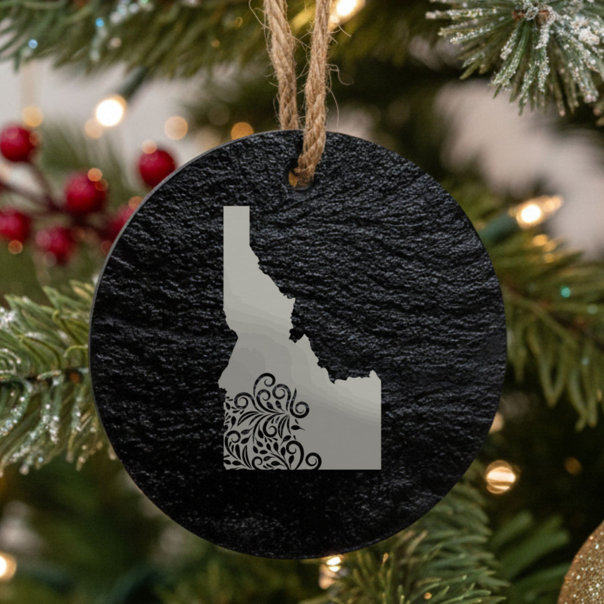 Idaho round slate Christmas ornament engraved with the state shape in ornate floral scrollwork