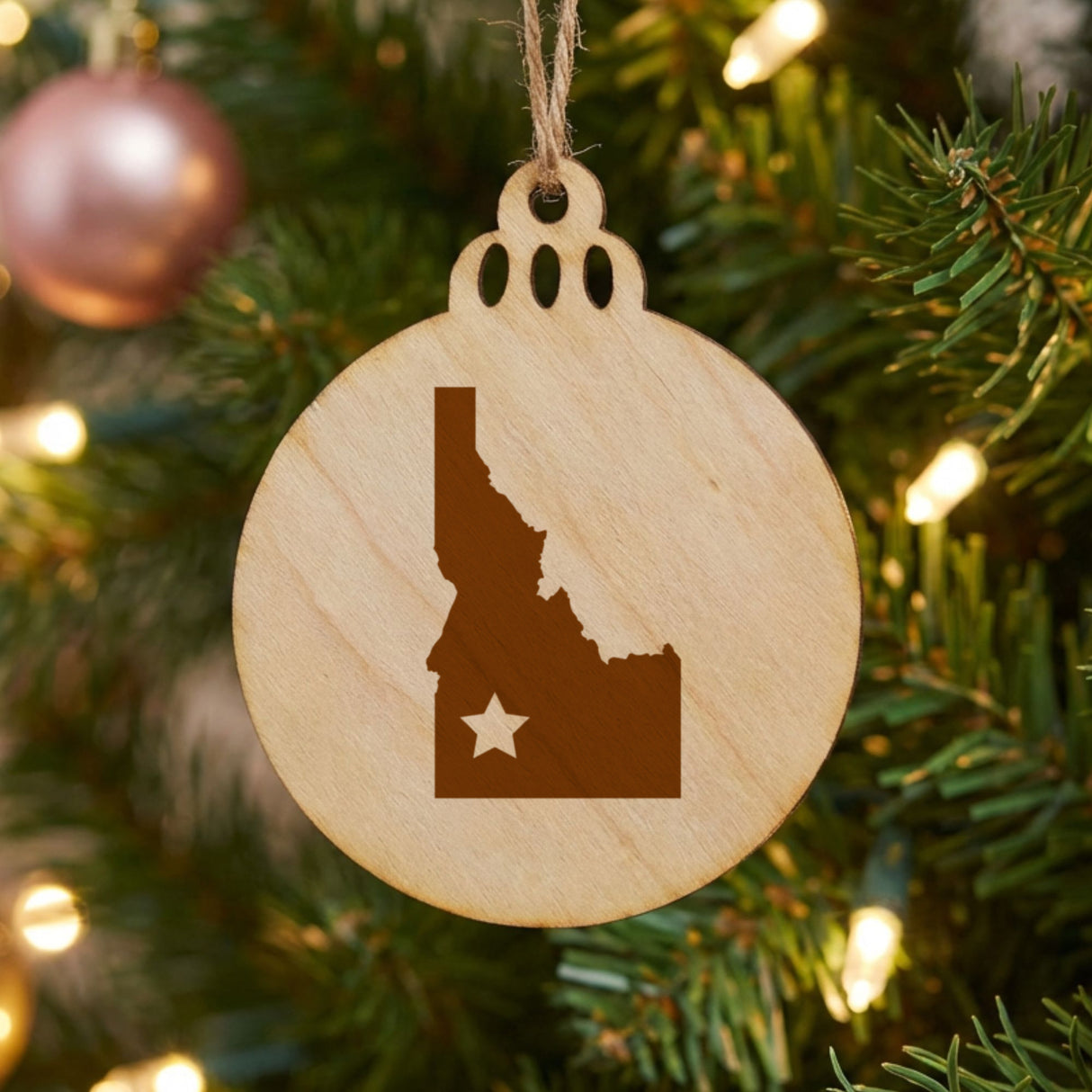 Idaho round wood Christmas ornament engraved with the state shape and a star