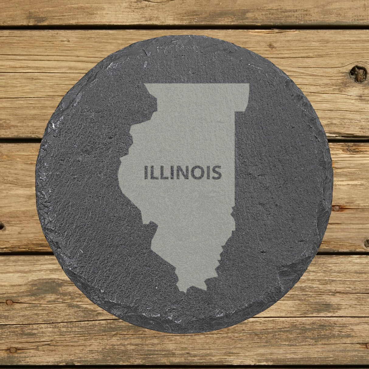 Illinois round slate coaster engraved with the state shape and ILLINOIS in bold lettering