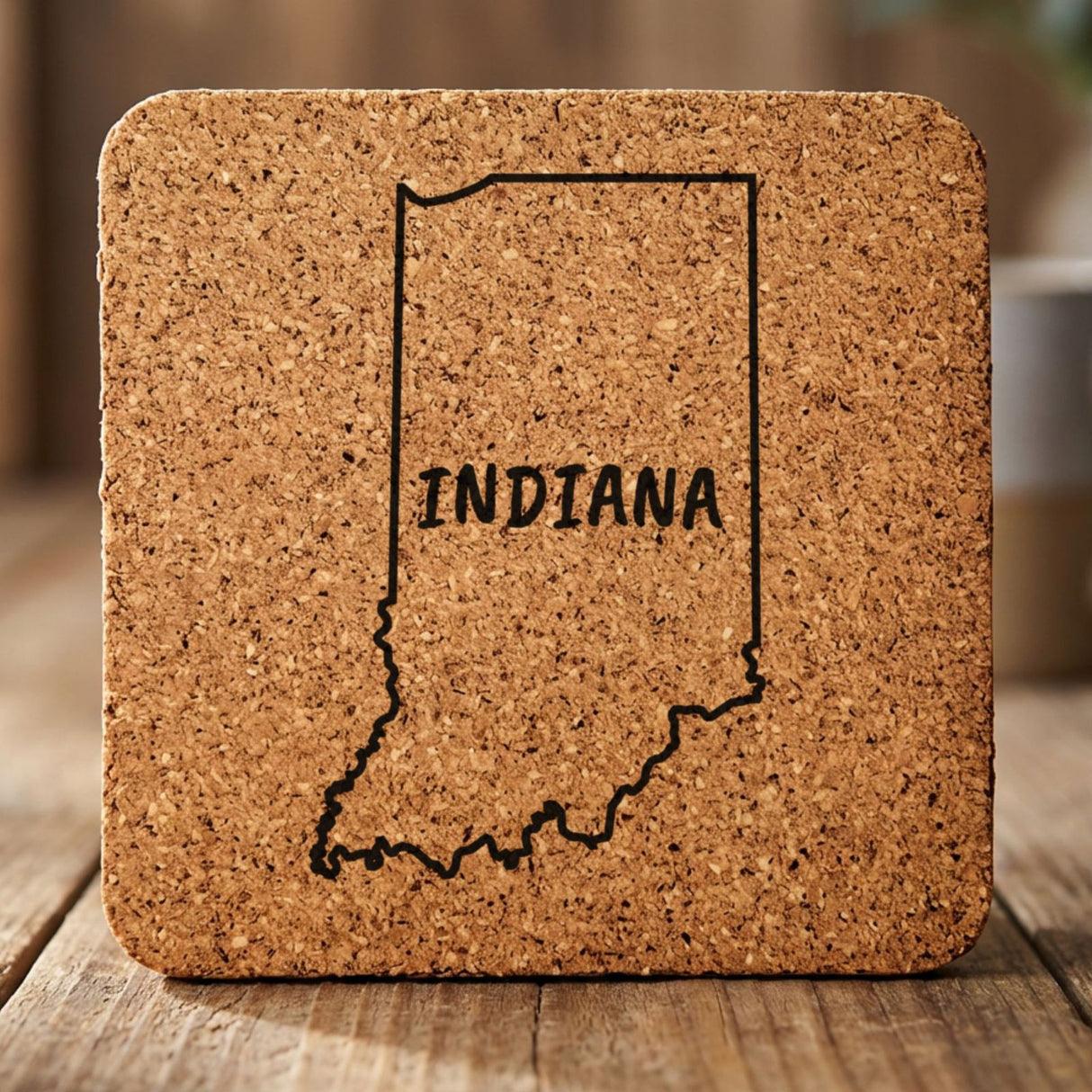 Indiana square cork coaster engraved with the state outline and INDIANA in hand-drawn brush lettering