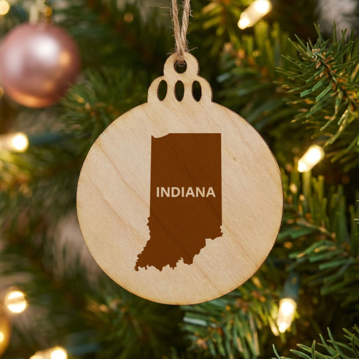 Indiana round wood Christmas ornament engraved with the state shape and INDIANA in bold lettering