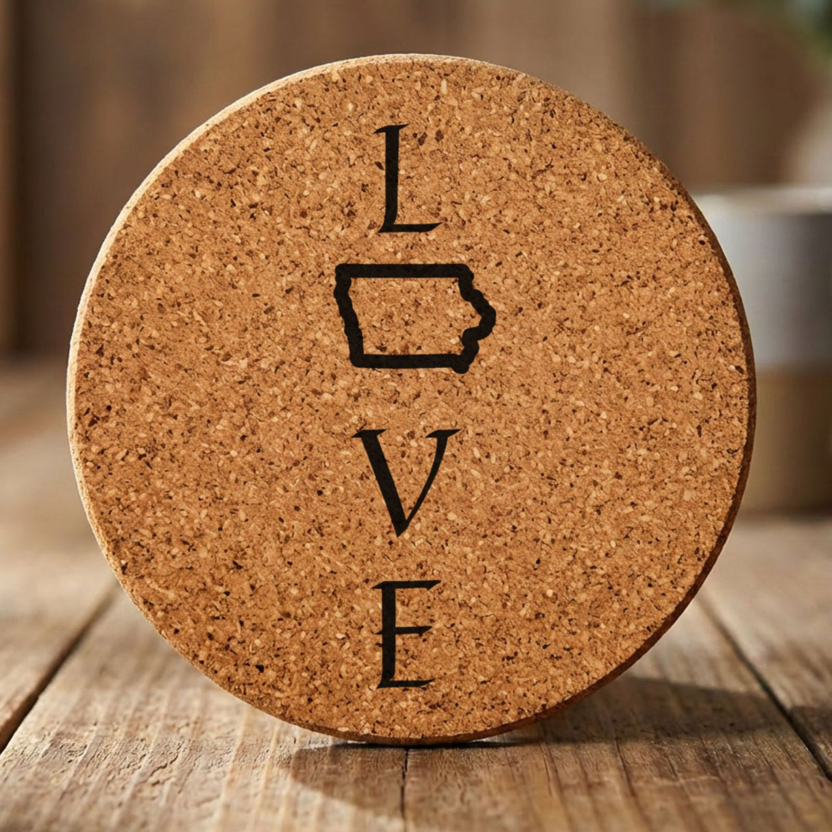 Iowa round cork coaster engraved with LOVE stacked vertically using the state as the letter O